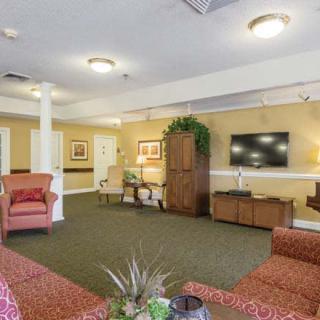 A cozy living room with comfortable seating, a television, and warm decor.