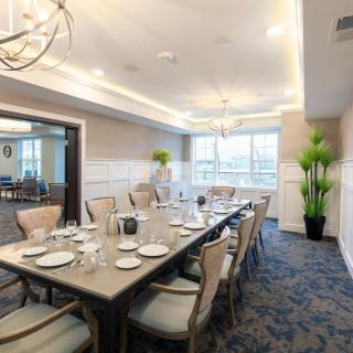 An elegantly decorated dining room with a large table set for a meal.