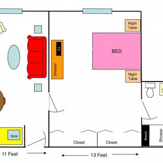 Floor plan of a bedroom with furniture and dimensions marked.