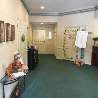 A decorated hallway with autumn-themed decorations and artwork.
