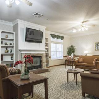 A cozy living room featuring comfortable sofas, a fireplace, and a wall-mounted television.