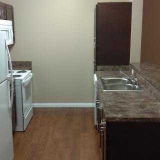A compact kitchen featuring modern appliances and a clean design.