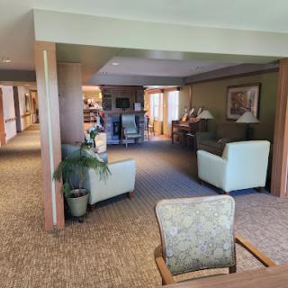 A cozy communal lounge area with comfortable seating and warm lighting.