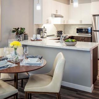 A modern open-concept kitchen and dining area with sleek furnishings.