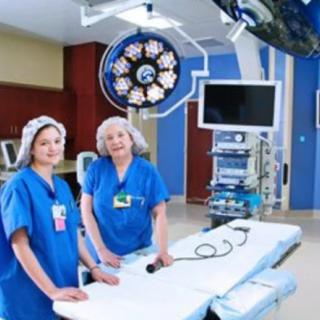 Two medical professionals in an operating room setting.