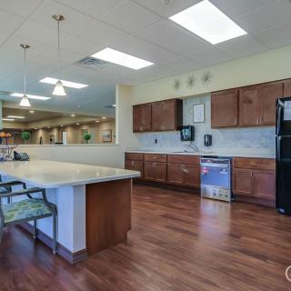 A spacious kitchen with wooden cabinets, modern appliances, and a large countertop island.