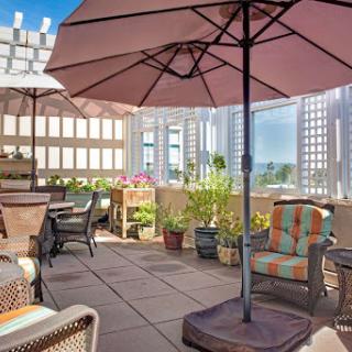 A cozy outdoor patio retreat with comfortable seating and umbrellas for shade.