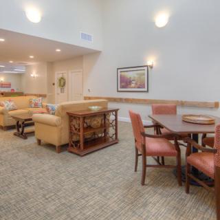 A spacious and comfortable interior featuring a living area and dining set.