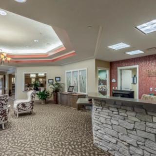 A welcoming lobby with a stone reception desk and comfortable seating.