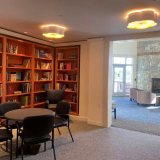 A cozy library corner with bookshelves and a reading area.