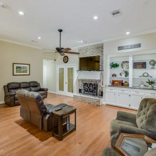 A cozy living room with comfortable seating, a fireplace, and tasteful decor.