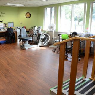 A bright and spacious rehabilitation therapy room equipped with various exercise tools and a welcoming atmosphere.