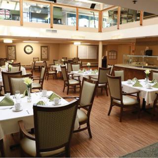 A well-lit restaurant dining area with neatly arranged tables and chairs.