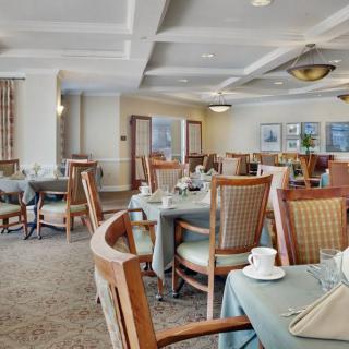 A stylish dining room with neatly arranged tables and chairs.
