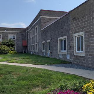 A view of the exterior of a building showcasing its architectural design and surrounding greenery.