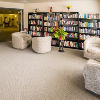 A cozy reading area with bookshelves and comfortable armchairs.
