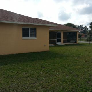 A suburban house with a well-maintained backyard.