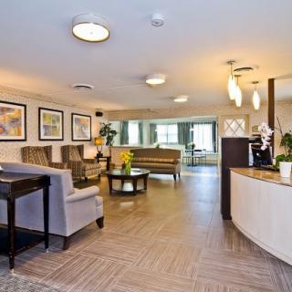 A modern lobby with comfortable seating and a reception desk.