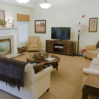 A cozy living room with a television, fireplace, and comfortable seating.