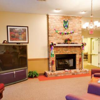 A cozy living room with a brick fireplace and comfortable seating.