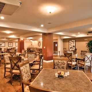 A well-lit indoor dining area with neatly arranged tables and chairs.