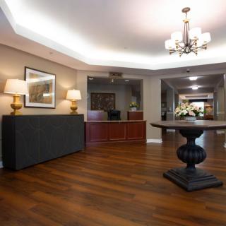 A stylish lobby with elegant lighting and wooden flooring.