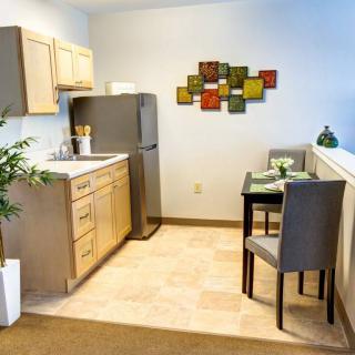 A compact and modern kitchen with a dining area.