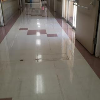 A clean and well-lit hallway with a polished floor.