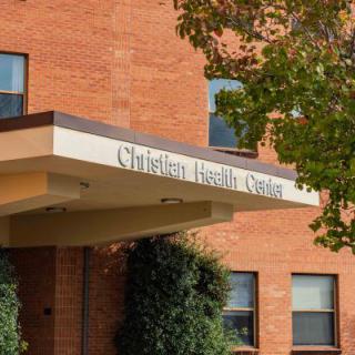 Entrance to a health center with brick exterior and visible signage.