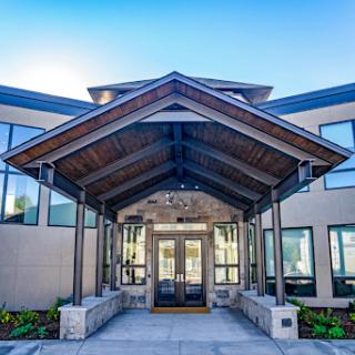 A modern building entrance featuring a stylish canopy and large windows.