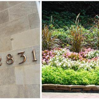 A building wall displaying the address '2831' next to a colorful garden with various plants and flowers.