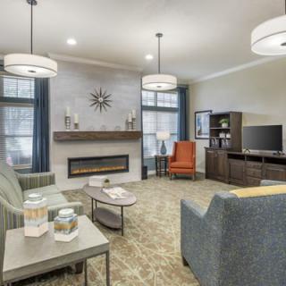 A modern living room with a cozy fireplace and stylish seating arrangement.