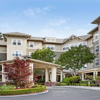 A multi-story residential building with landscaped surroundings.
