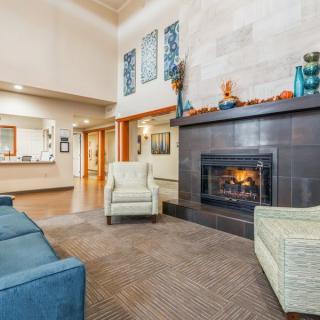 A cozy lobby with comfortable seating and a fireplace.