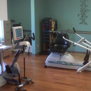 A small fitness room with exercise machines and equipment.