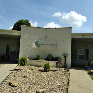A well-maintained building with landscaping in a sunny setting.