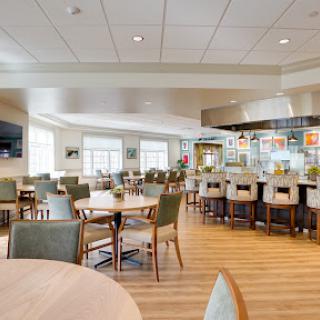 A spacious and modern dining area featuring comfortable seating and a bright atmosphere.