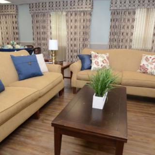 A cozy living room with beige sofas, a wooden coffee table, and decorative cushions.