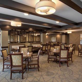 A modern dining room with elegant seating and ambient lighting.