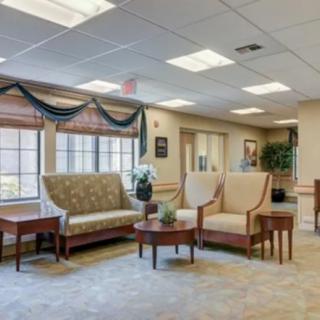 A well-lit lobby area with comfortable seating and elegant decor.