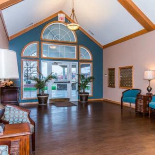 A well-lit lobby with comfortable seating and decorative plants.