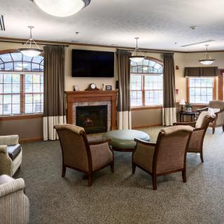 A cozy living room with a fireplace, television, and comfortable seating.