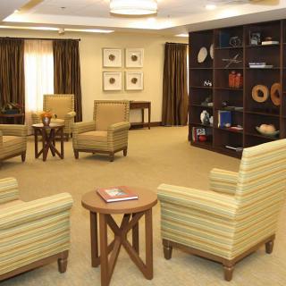 A cozy lounge area with comfortable seating and a stylish bookshelf.