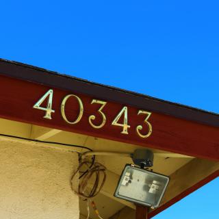 House number 40343 displayed on the exterior of a building under a clear blue sky.