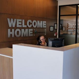 A warm and inviting reception area featuring a 'Welcome Home' sign.