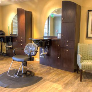 A modern hair salon with stylish chairs and mirrors, designed for a comfortable haircut experience.