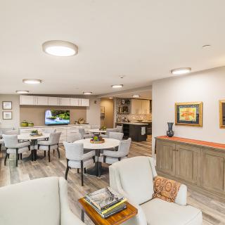 A modern living and dining area with neutral tones and stylish furniture.
