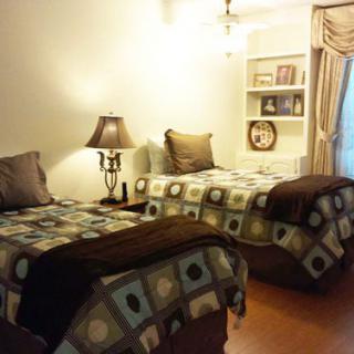 A cozy bedroom with twin beds and a warm ambiance.