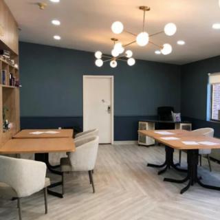 A modern office space with stylish furniture and contemporary lighting.