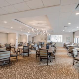 An elegant dining room with neatly arranged tables and chairs.